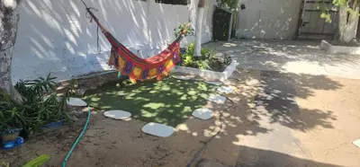 a hammock is tied to a tree in a yard at Casa de Playa Salgar in Puerto Colombia