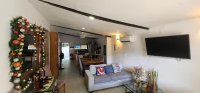 a living room with a christmas tree and a tv at Casa de Playa Salgar in Puerto Colombia