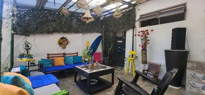 a living room with a blue couch and chairs at Casa de Playa Salgar in Puerto Colombia