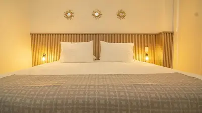 a bedroom with a bed with two clocks on the wall at Exclusive New 1-BR Apartment in Baia Kristal Kabo in Los Arrayanes