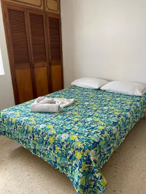 a bed with two towels on top of it at Altamar suite Cabrero in Cartagena de Indias