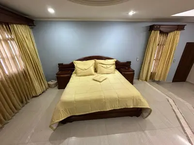 a bedroom with a bed with a yellow blanket on it at Casa Rey Colonial 1910 Manga - 7 Habitaciones in Cartagena de Indias