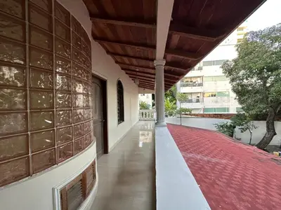 a hallway of a building with a red rug at Casa Rey Colonial 1910 Manga - 7 Habitaciones in Cartagena de Indias