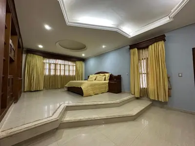 a bedroom with a bed in the middle of a room at Casa Rey Colonial 1910 Manga - 7 Habitaciones in Cartagena de Indias