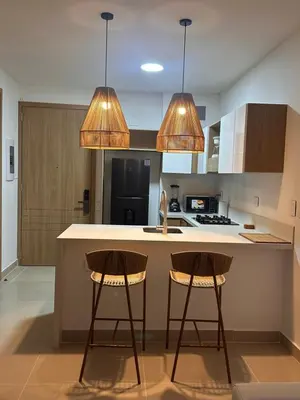 a kitchen with two bar stools and two lights at Baia Kristal Cartagena in Cartagena de Indias