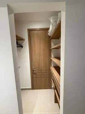 a walk in closet with a wooden door at Baia Kristal Cartagena in Cartagena de Indias