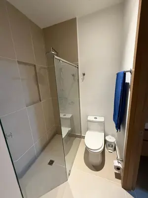 a bathroom with a toilet and a glass shower at Baia Kristal Cartagena in Cartagena de Indias