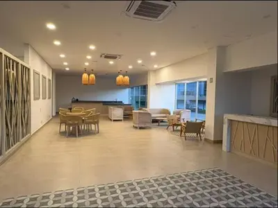 a large room with tables and chairs in a building at Baia Kristal Cartagena in Cartagena de Indias