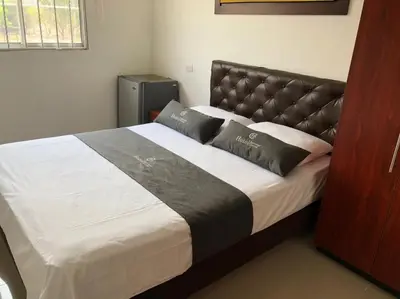 a bed with two pillows on it in a room at Hotel Aeromar Central in Santa Marta