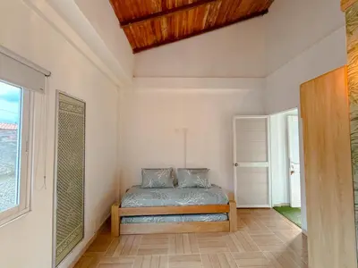 a bedroom with a bed and a window at Villa Martina in Moñitos