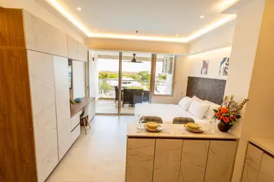 a hotel room with a bed and a kitchen at Magica Cartagena Suite in Cartagena de Indias