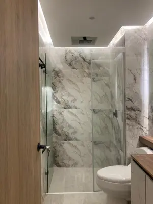 a bathroom with a glass shower with a toilet at Magica Cartagena Suite in Cartagena de Indias