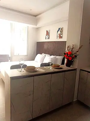 a bedroom with a bed and a table with plates on it at Magica Cartagena Suite in Cartagena de Indias