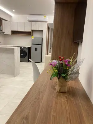 a vase of flowers sitting on a wooden table in a kitchen at Magica Cartagena Suite in Cartagena de Indias