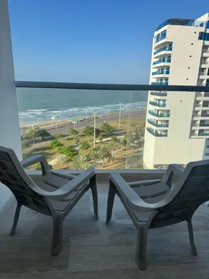 two chairs on a balcony with a view of the ocean at Relax vista al mar Aparta suite in Cartagena de Indias