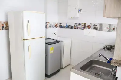 a kitchen with a white refrigerator and a sink at Apartamento 3 hab a paso del mar in Cartagena de Indias