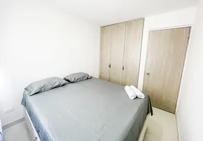 a bedroom with a bed with two white towels on it at Apartamento 3 hab a paso del mar in Cartagena de Indias
