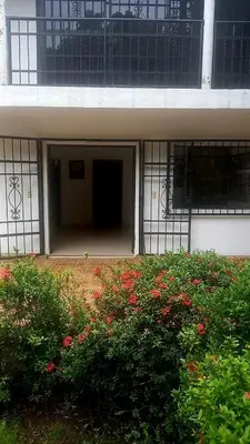an entrance to a building with a bunch of flowers at Cabaña Turística a Pasos del Mar, Ideal para Grupo in San Antero