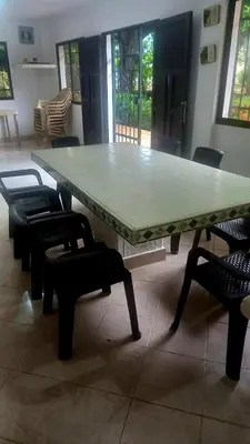 a large table with chairs around it in a room at Cabaña Turística a Pasos del Mar, Ideal para Grupo in San Antero