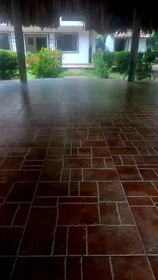 a stone patio with a building in the background at Cabaña Turística a Pasos del Mar, Ideal para Grupo in San Antero