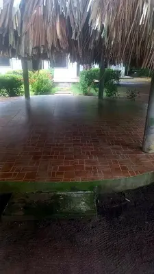 a brick patio with a straw roof at Cabaña Turística a Pasos del Mar, Ideal para Grupo in San Antero