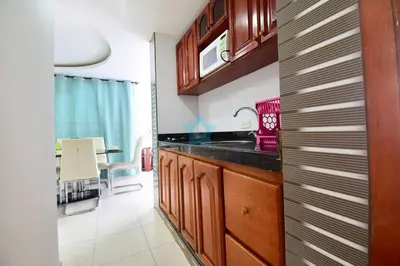 a kitchen with wooden cabinets and a sink at apartamento con balcon p6 in Cartagena de Indias