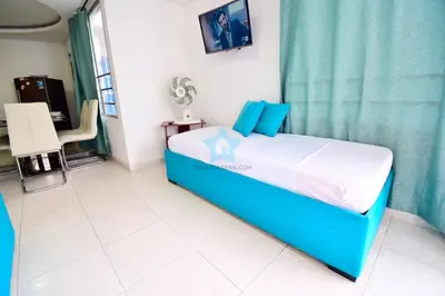 a bedroom with a blue bed in a room at apartamento con balcon p6 in Cartagena de Indias