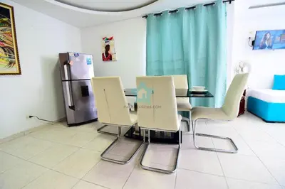 a dining room with a table and chairs and a refrigerator at apartamento con balcon p6 in Cartagena de Indias
