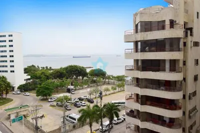 an apartment building with a parking lot in front of the ocean at apartamento con balcon p6 in Cartagena de Indias