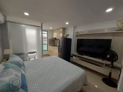 a bedroom with a bed and a flat screen tv at Apartaestudio al frente del Mar in Cartagena de Indias