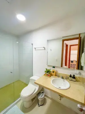 a bathroom with a toilet and a sink and a mirror at Espectacular apartamento vista al mar in Cartagena de Indias
