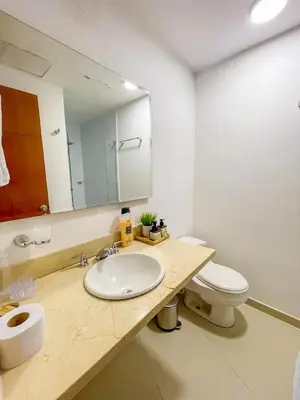 a bathroom with a sink and a toilet and a mirror at Espectacular apartamento vista al mar in Cartagena de Indias