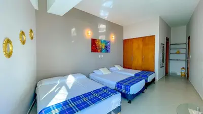 a bedroom with two beds and a painting on the wall at Espectacular apartamento vista al mar in Cartagena de Indias
