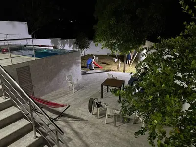 a group of chairs and a table next to a pool at Private pool cabin near the sea Puerto Velero in Tubará