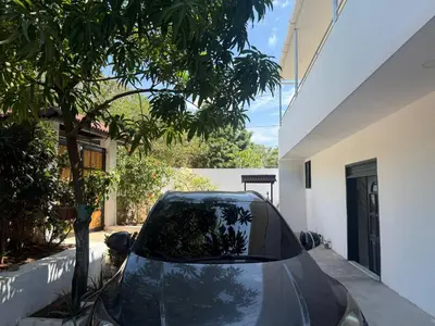 a car parked in the driveway of a house at Private pool cabin near the sea Puerto Velero in Tubará