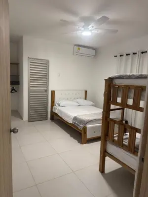 a bedroom with two bunk beds and a ceiling fan at Private pool cabin near the sea Puerto Velero in Tubará