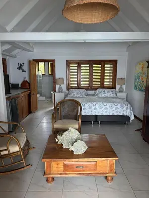 a bedroom with a bed and a wooden coffee table at Accommodation on a coral island with turquoise sea in Cartagena de Indias