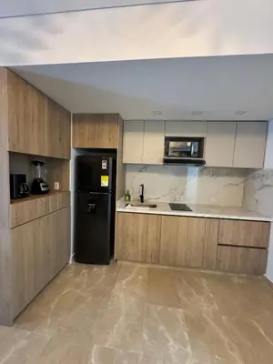 a kitchen with a black refrigerator in a room at Cartagena Beach Resort in Cartagena de Indias
