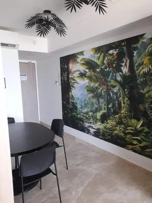 a dining room with a large painting on the wall at Cartagena Beach Resort in Cartagena de Indias