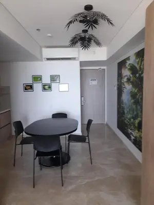 a dining room with a black table and chairs at Cartagena Beach Resort in Cartagena de Indias