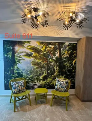 two chairs and a table in front of a mural at Cartagena Beach Resort in Cartagena de Indias