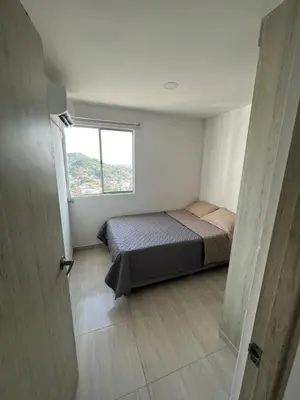 a small bedroom with a bed and a window at Alina Beautiful Cartagena Apartment in Cartagena de Indias