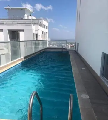 a swimming pool on the roof of a building at Alina Beautiful Cartagena Apartment in Cartagena de Indias