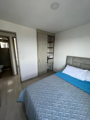 a bedroom with a large bed with a blue blanket at Alina Beautiful Cartagena Apartment in Cartagena de Indias