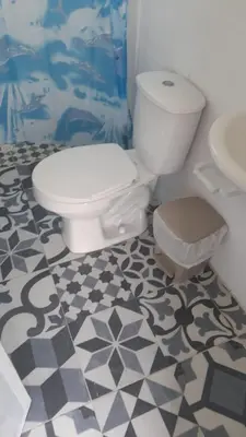a bathroom with a toilet and a sink at CABAÑA el EDEN in Santa Veronica
