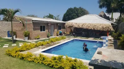 a man is in a pool in a yard at CABAÑA el EDEN in Santa Veronica