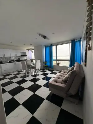 a living room with a couch and a checkered floor at MnM Vacation Rentals in Cartagena de Indias