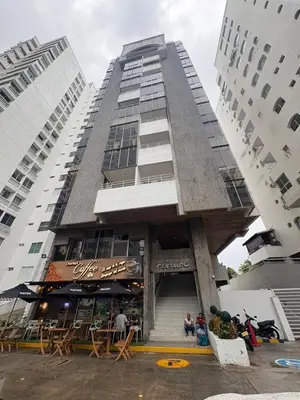 a tall building with a restaurant in front of it at MnM Vacation Rentals in Cartagena de Indias