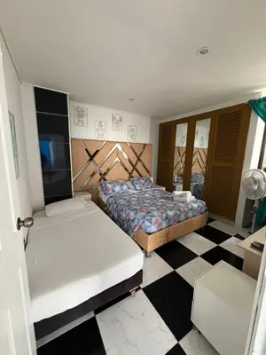 a bedroom with two beds and a checkered floor at MnM Vacation Rentals in Cartagena de Indias