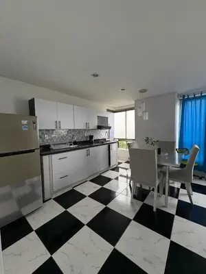 a kitchen with a black and white checkered floor at MnM Vacation Rentals in Cartagena de Indias